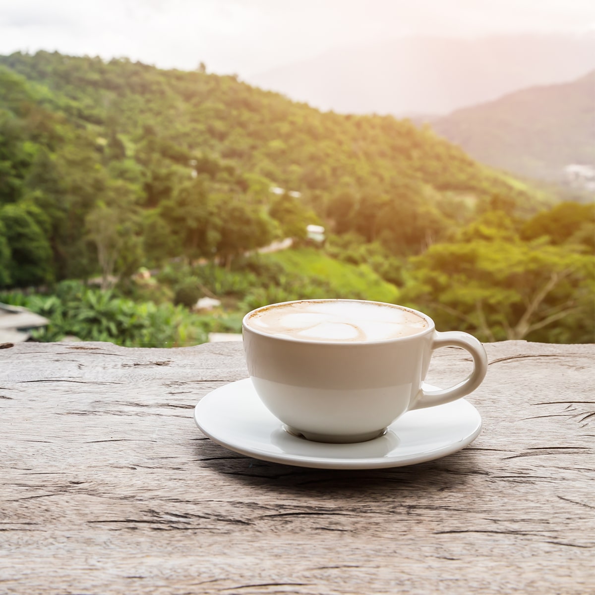 Aroma Expeditions - Scenic View of a Coffee Cup on a Wooden Table with Mountain View Background