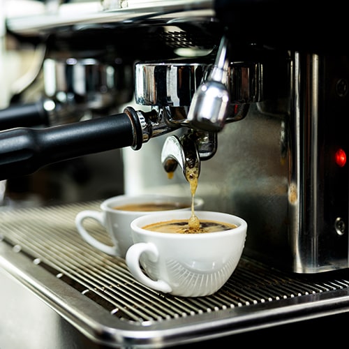 Coffee Acidity and Body — Espresso Machine Pouring Espresso into a White Cup