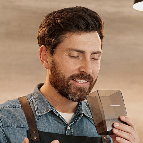 Coffee Aroma and Taste — Man Smelling Ground Coffee Man Smelling the Aroma of Freshly Ground Coffee