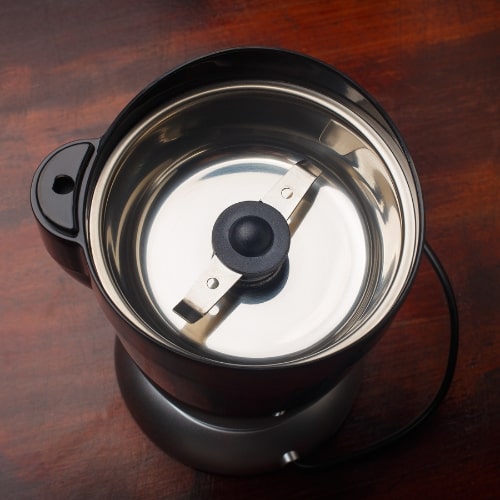 How to Choose a Coffee Grinder — Electric Coffee Grinder Blades Inside View of Electric Coffee Grinder Showing Blades