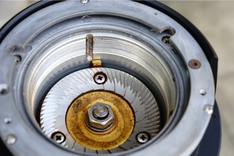 How to Choose a Coffee Grinder — Close-Up of a Flat Burr Coffee Grinder How to Choose a Coffee Grinder — Close-Up of a Flat Burr Coffee Grinder Showing Burr Mechanism