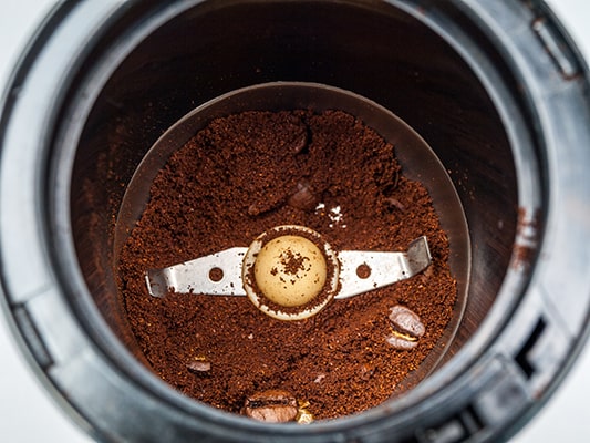 A Blade Coffee Grinder with Ground Coffee Showing the Blades