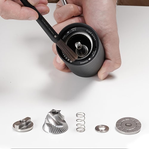 Cleaning the Burrs of a Manual Coffee Grinder with a Brush