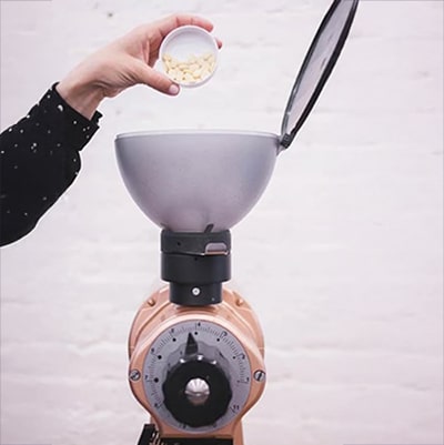 Pouring Cleaning Tablets into Coffee Grinder Hopper