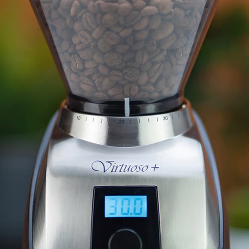 Hopper Filled with Coffee Beans on Baratza Virtuoso+ Conical Burr Coffee Grinder Close-up View of Baratza Virtuoso+ Hopper Filled with Coffee Beans