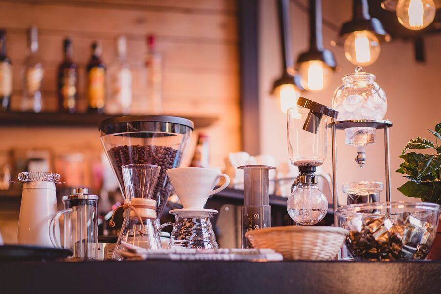 A Coffee Bar Featuring a Siphon Coffee Maker, a Pour-Over Station, and a Grinder